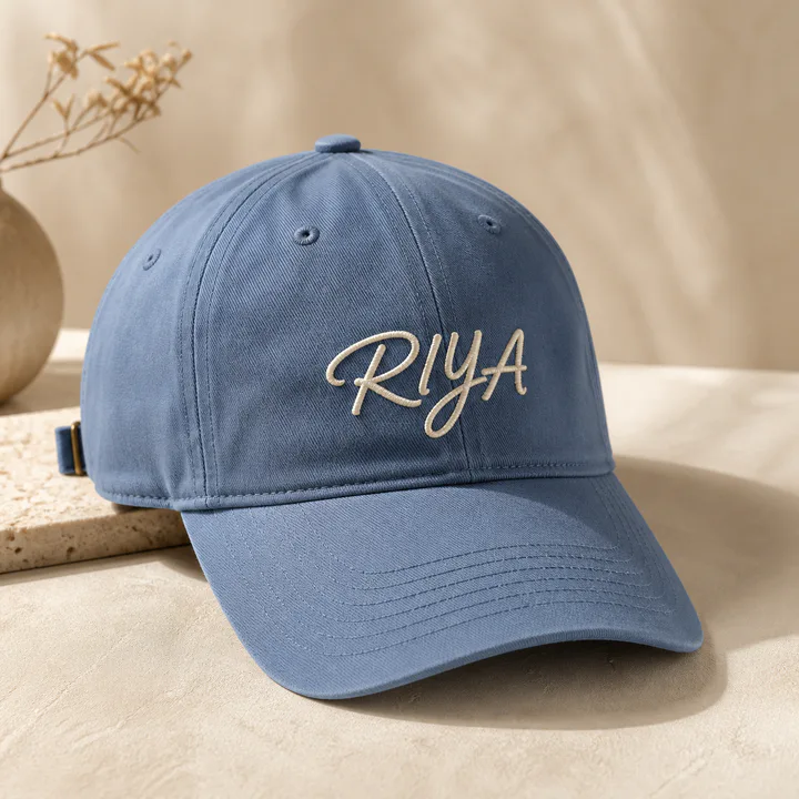 Dusty blue cap embroidered with a personalized script name