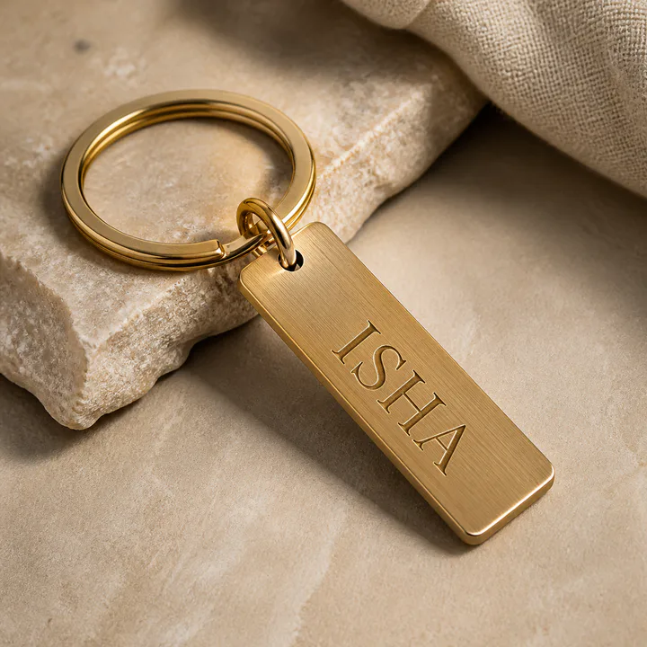 Brushed brass keychain engraved with a personalized name