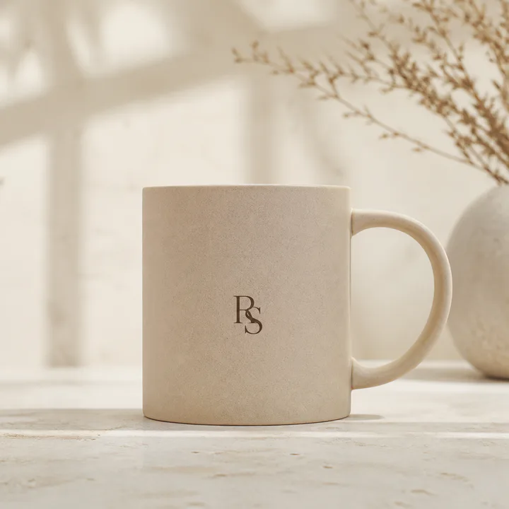Matte sand mug with a small interlocking monogram