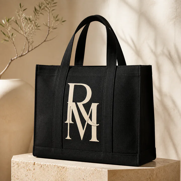 Black cotton tote with an oversized cream monogram
